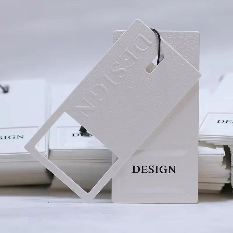 Wholesale Customized Logo Clothing Tags Recyclable Fashionable Embossed Paper Hang Tags Hollow Printing Swing Tags for Bags